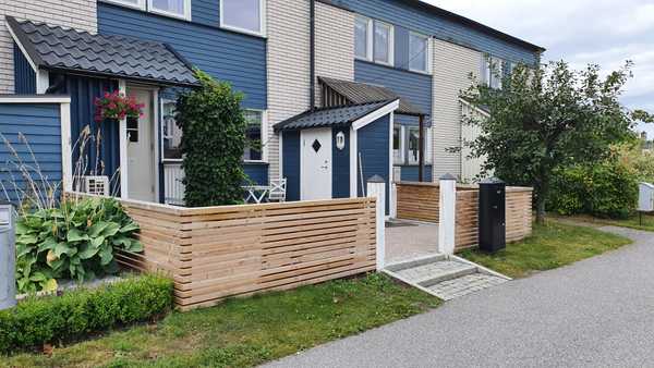 Trästaket runt entré till hus.