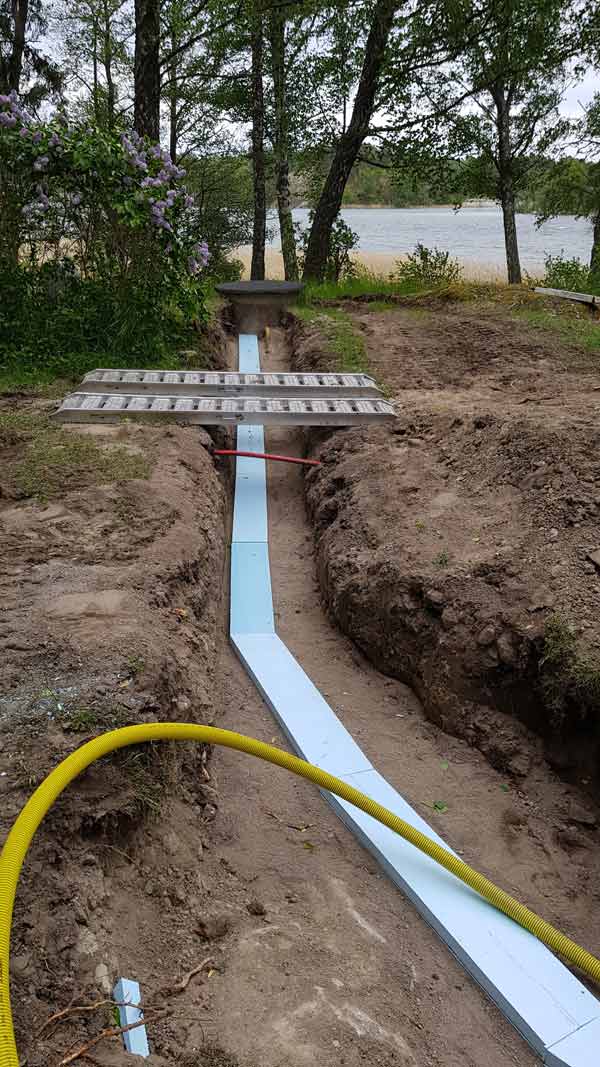Ett rör som leder fram till en brunn vid vattnet.